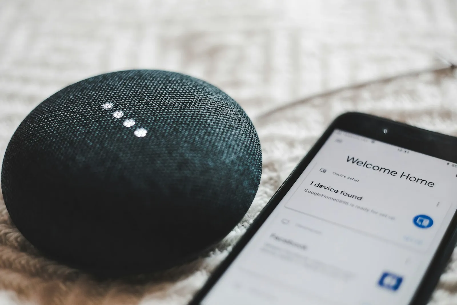 Google Home Mini smart speaker with a smartphone