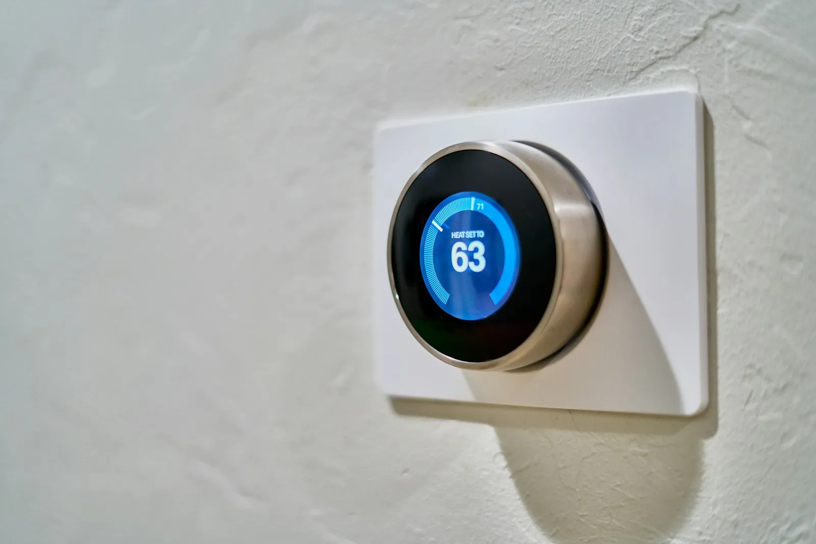 Nest smart thermostat mounted on a wall