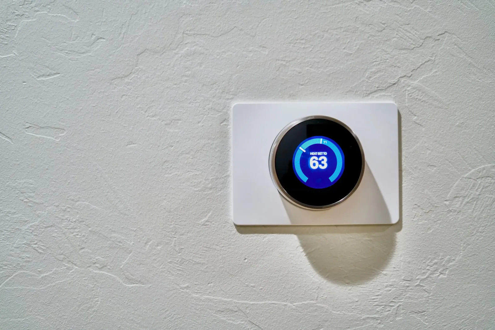 Smart thermostat displaying 62 degrees